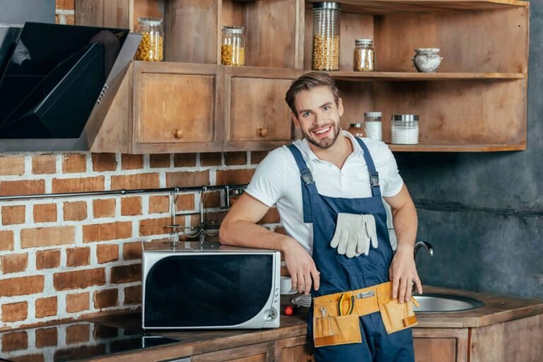 Quick Repair technician repairing an electric oven in a Dubai kitchen